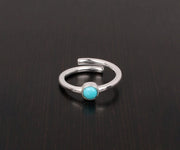 Artisan turquoise gemstone ring with radiant silver setting and bold, bohemian charm